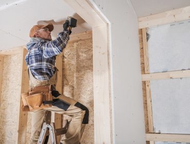 Home restoration in Rhode Island showing exposed framing and licensed contractors at work